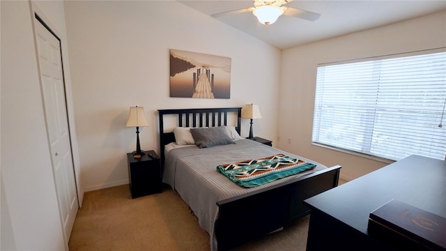 bedroom with lofted ceiling, light carpet, and ceiling fan