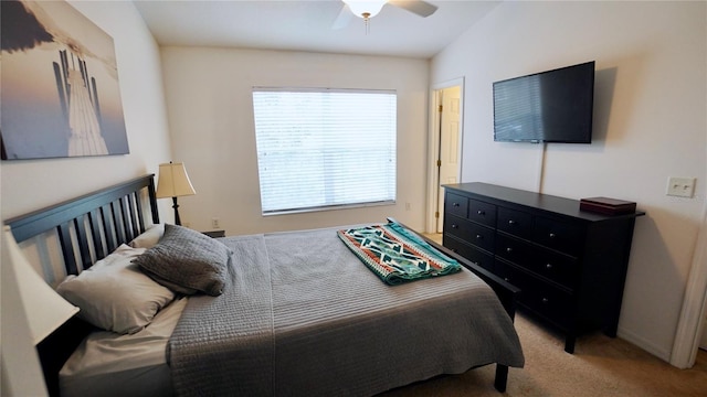 bedroom with ceiling fan, light colored carpet, and lofted ceiling