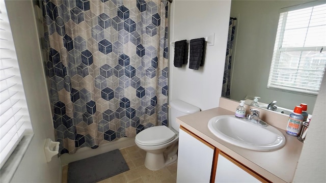 bathroom featuring tile patterned flooring, vanity, and toilet