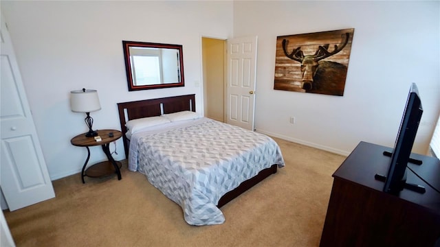 bedroom with light carpet and baseboards