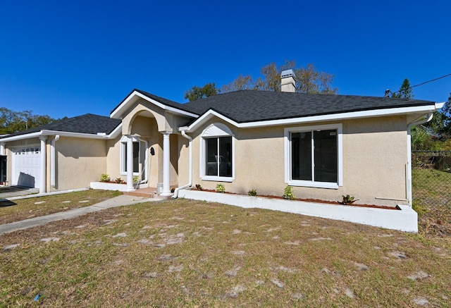 ranch-style house with a garage and a front yard