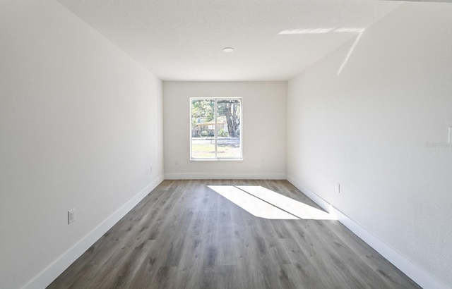 spare room with wood-type flooring