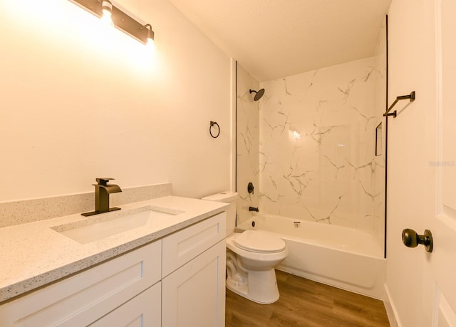 full bathroom featuring vanity, hardwood / wood-style flooring, toilet, and tiled shower / bath combo