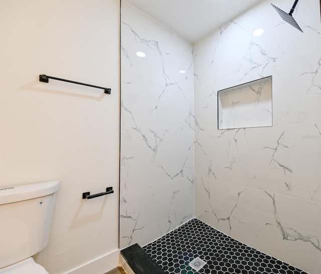 bathroom featuring toilet and tiled shower