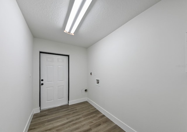 washroom featuring hookup for a washing machine, dark wood-type flooring, hookup for an electric dryer, and a textured ceiling