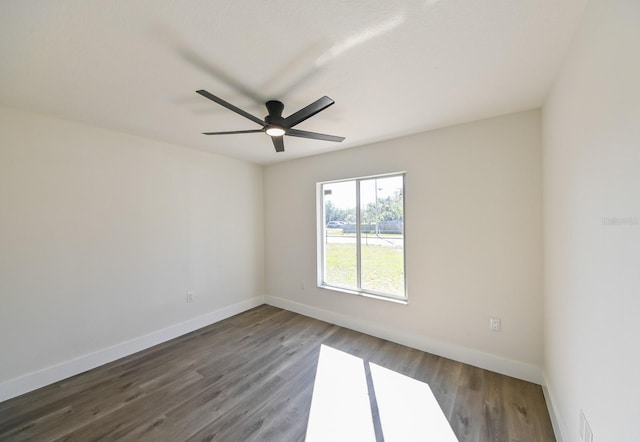 spare room with ceiling fan and dark hardwood / wood-style flooring