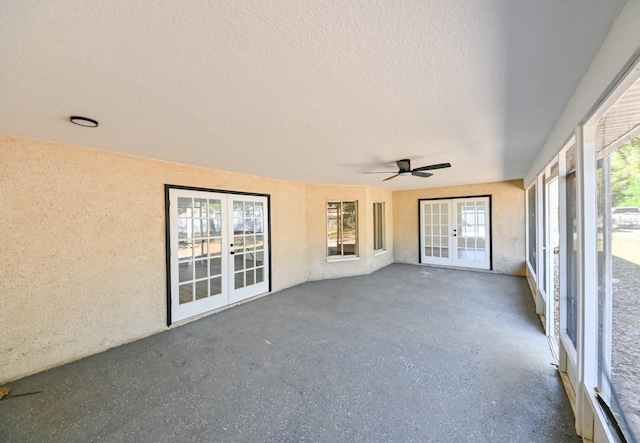 unfurnished sunroom featuring french doors and ceiling fan