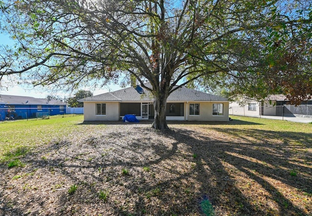 rear view of house featuring a lawn