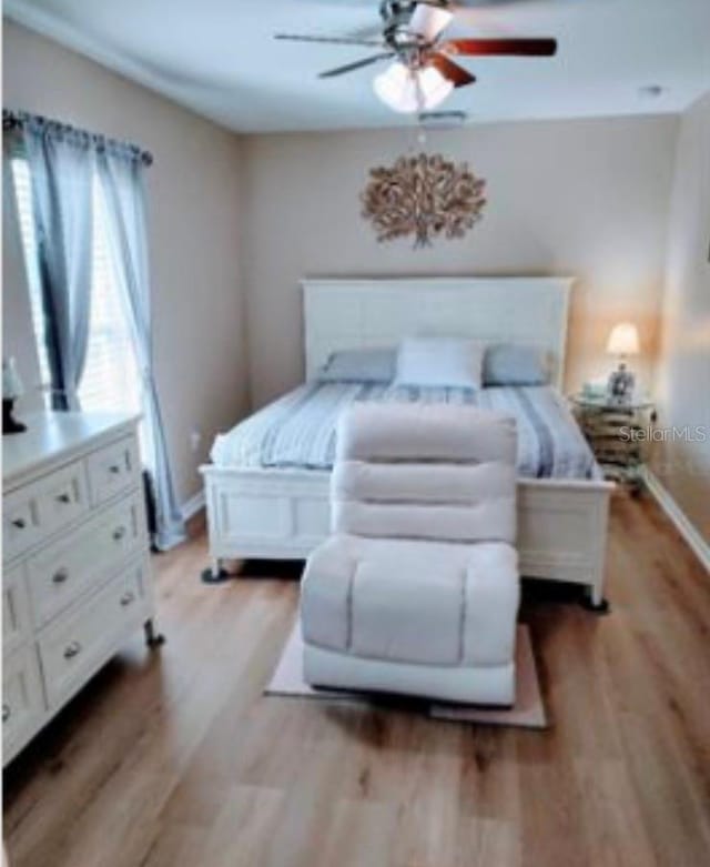 bedroom with light hardwood / wood-style flooring and ceiling fan