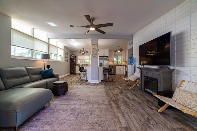 living room featuring ceiling fan and hardwood / wood-style floors