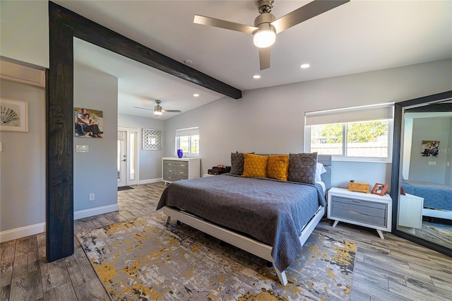 bedroom featuring ceiling fan, wood-type flooring, and lofted ceiling with beams