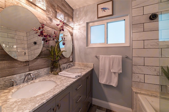 bathroom with vanity and a tub