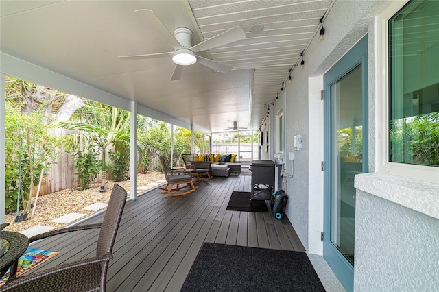 deck featuring an outdoor living space and ceiling fan