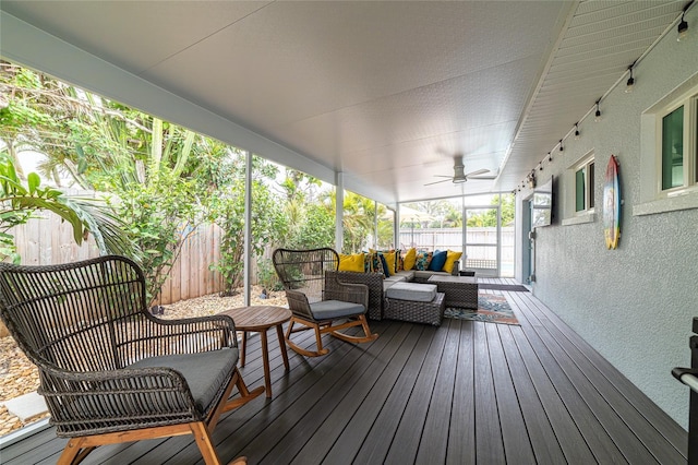 deck featuring ceiling fan and outdoor lounge area