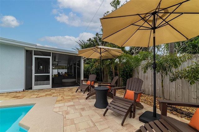 view of patio with a fenced in pool and a sunroom