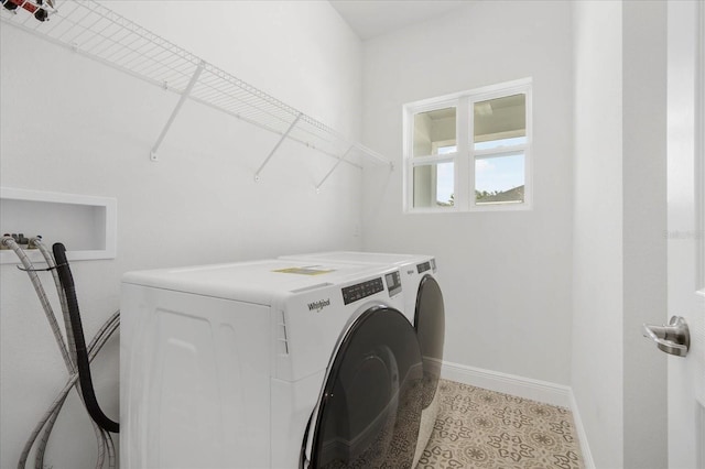 laundry area with light tile patterned floors and independent washer and dryer