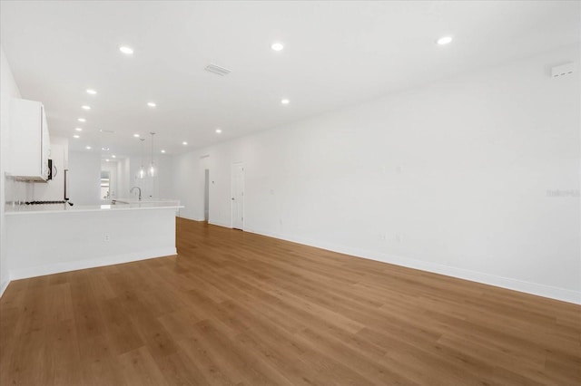 unfurnished living room featuring hardwood / wood-style flooring