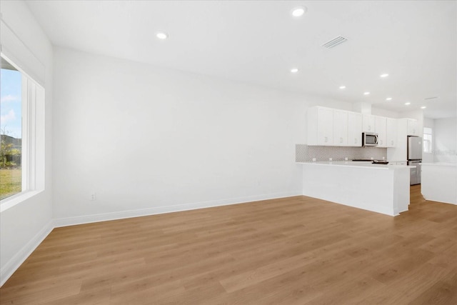 unfurnished living room with light wood-type flooring