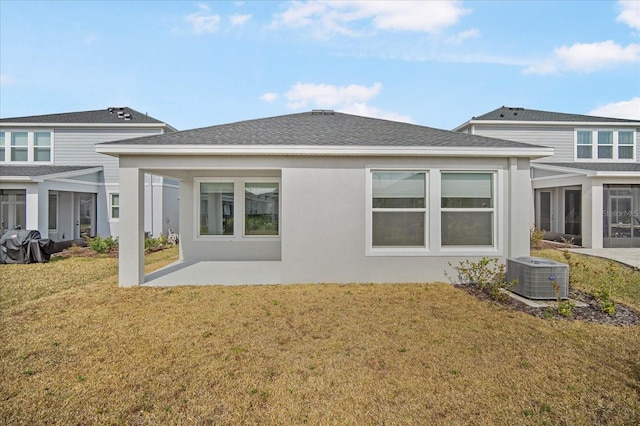 back of property featuring a patio area, a lawn, and central air condition unit