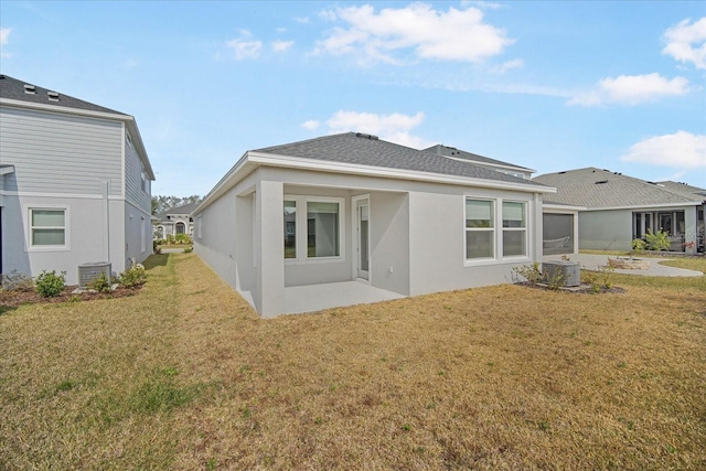 rear view of property featuring a yard and a patio