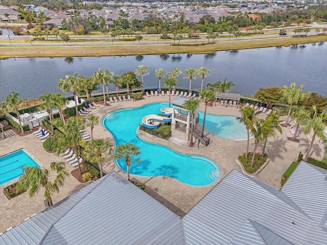 view of swimming pool featuring a patio and a water view