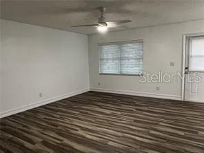 unfurnished room with dark wood-type flooring and ceiling fan