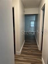 corridor featuring dark hardwood / wood-style floors