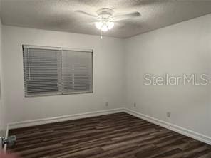 unfurnished room featuring a textured ceiling, dark hardwood / wood-style floors, and ceiling fan