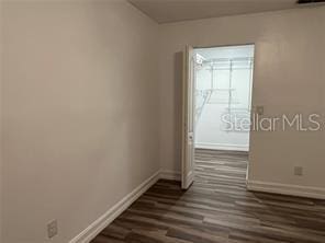 empty room featuring dark wood-type flooring