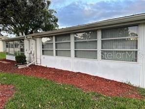 view of property exterior featuring a lawn