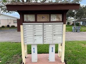 surrounding community featuring a mail area and a yard