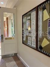 hallway with light tile patterned floors