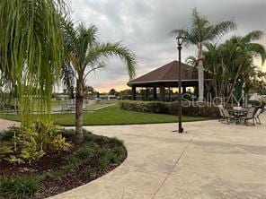 view of home's community with a gazebo, a lawn, and a patio area