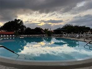 view of pool at dusk