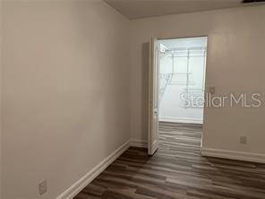 401 Dorchester Pl Unit 62, Sun City Center, FL 33573 - unfurnished room featuring baseboards and dark wood-type flooring