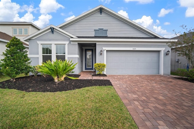 view of front of property with a garage and a front yard