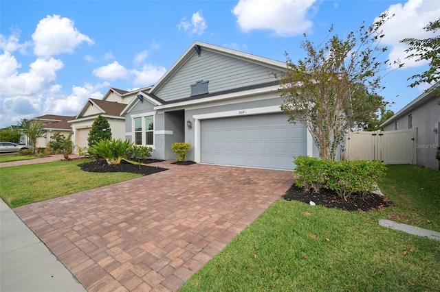 view of front of property featuring a garage and a front lawn