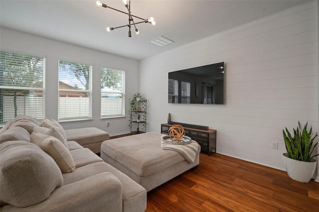 living room featuring dark hardwood / wood-style flooring and a chandelier