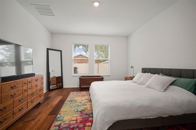 bedroom with dark hardwood / wood-style flooring