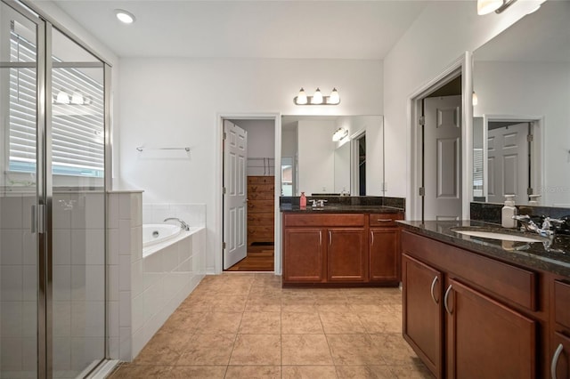 bathroom with vanity, tile patterned floors, and shower with separate bathtub