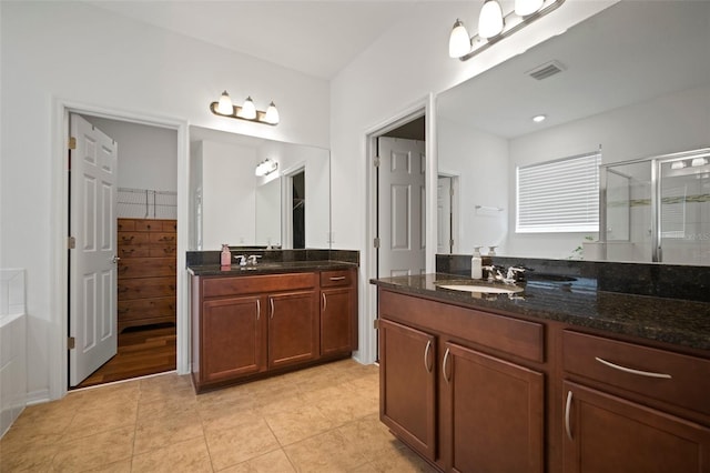 bathroom featuring tile patterned floors, vanity, and independent shower and bath