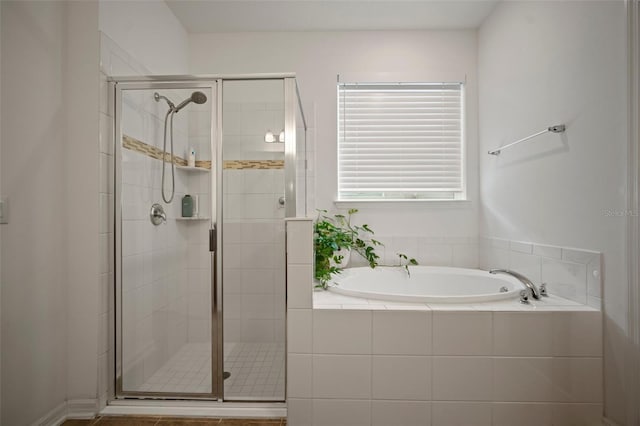 bathroom featuring independent shower and bath