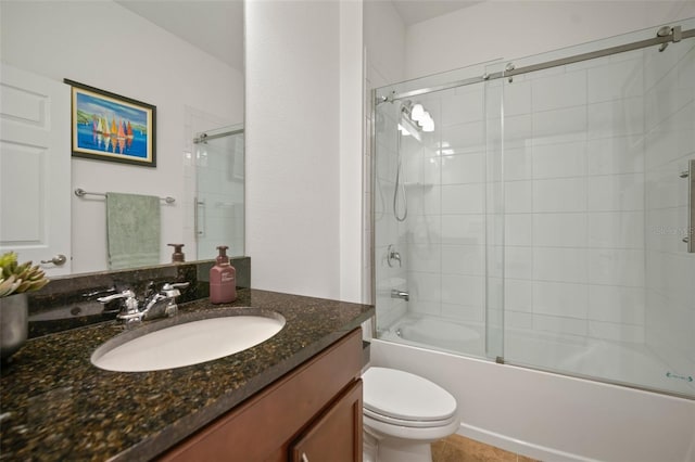 full bathroom with bath / shower combo with glass door, vanity, and toilet