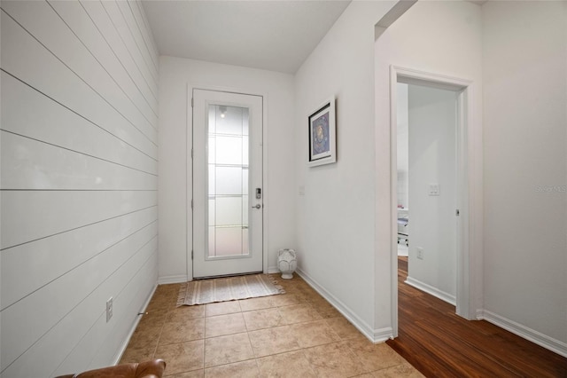 doorway with light tile patterned flooring