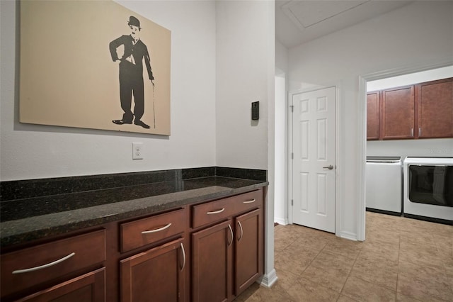 kitchen with dark stone counters and separate washer and dryer