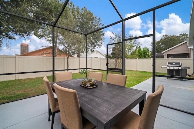 view of patio / terrace featuring a grill and a lanai