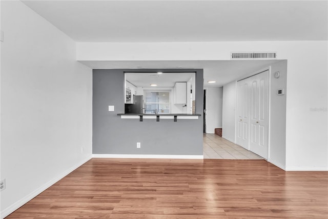 unfurnished living room featuring light hardwood / wood-style floors