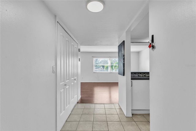 corridor with light tile patterned floors