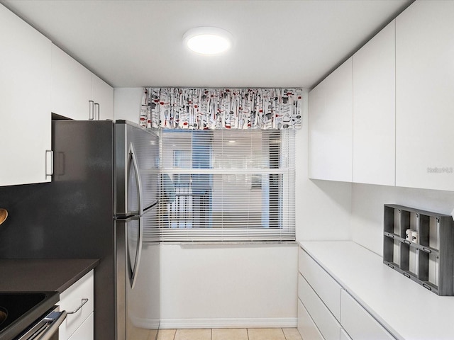 kitchen with light tile patterned flooring and white cabinets