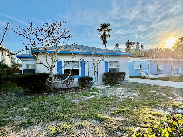 back of house with a lawn